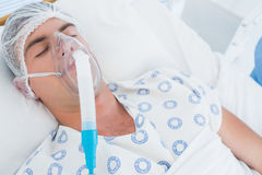 patient-lying-oxygen-mask-hospital-room-54251216.jpg